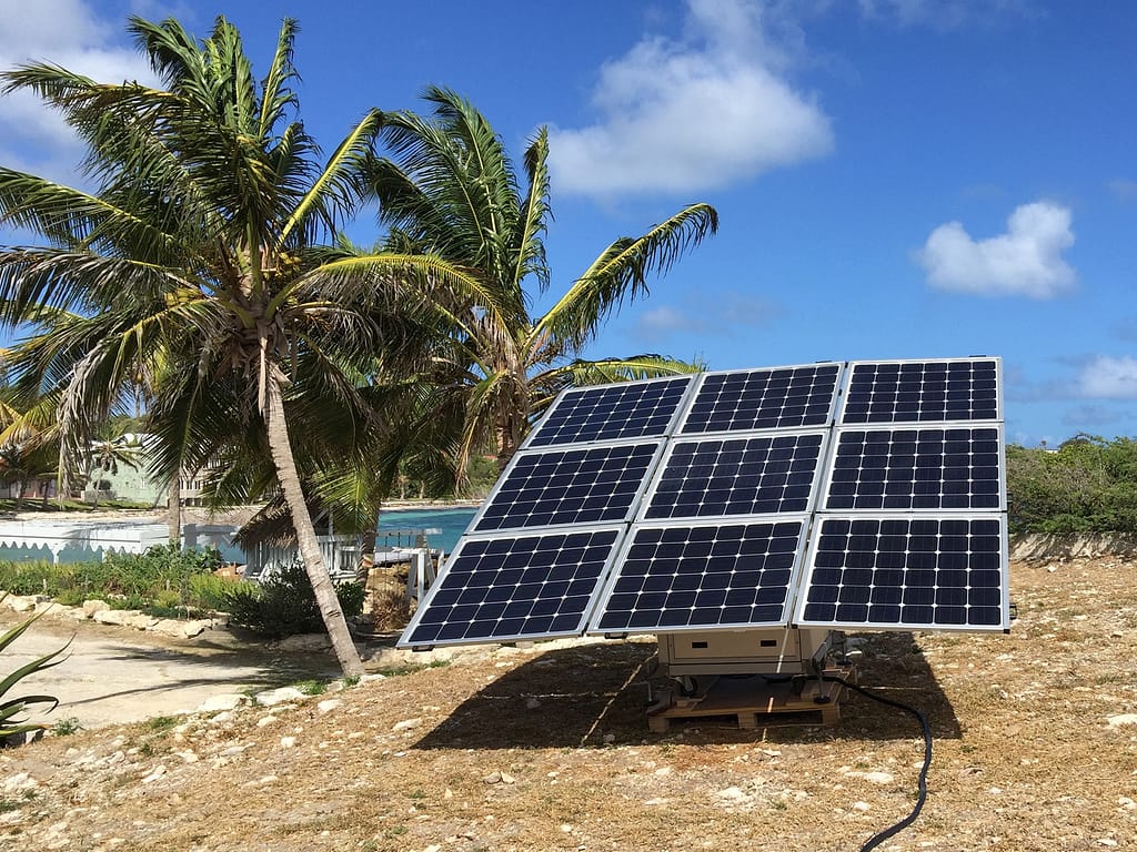 The sun2go xl off-grid solar solution installed in Antigua and Barbuda next to palm trees.
